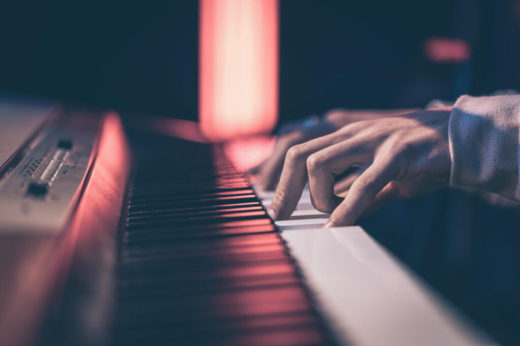 male hands playing the piano keys