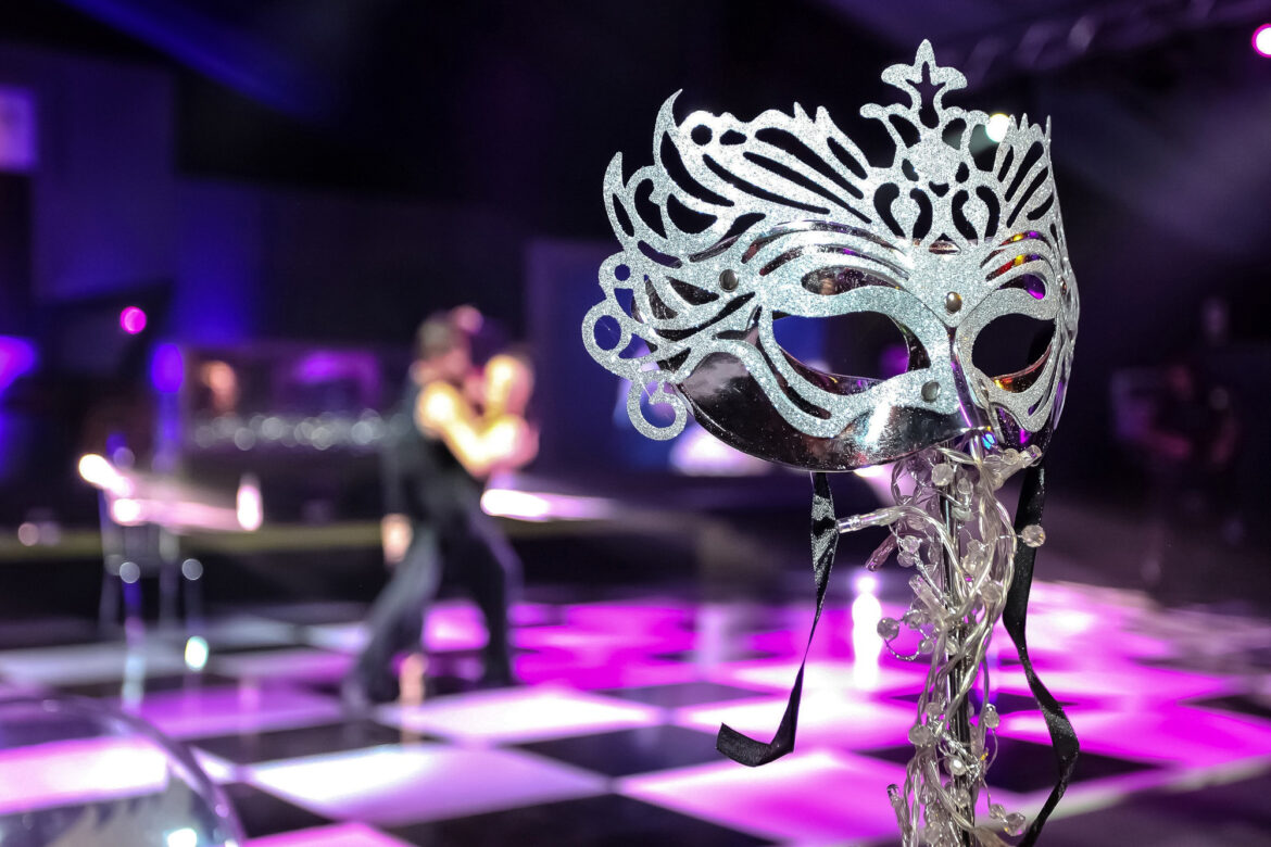 closeup shot of a mask with a couple dancing