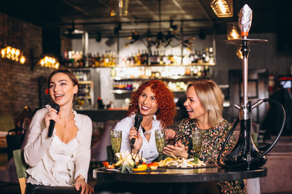 womens in a bar singing karaoke